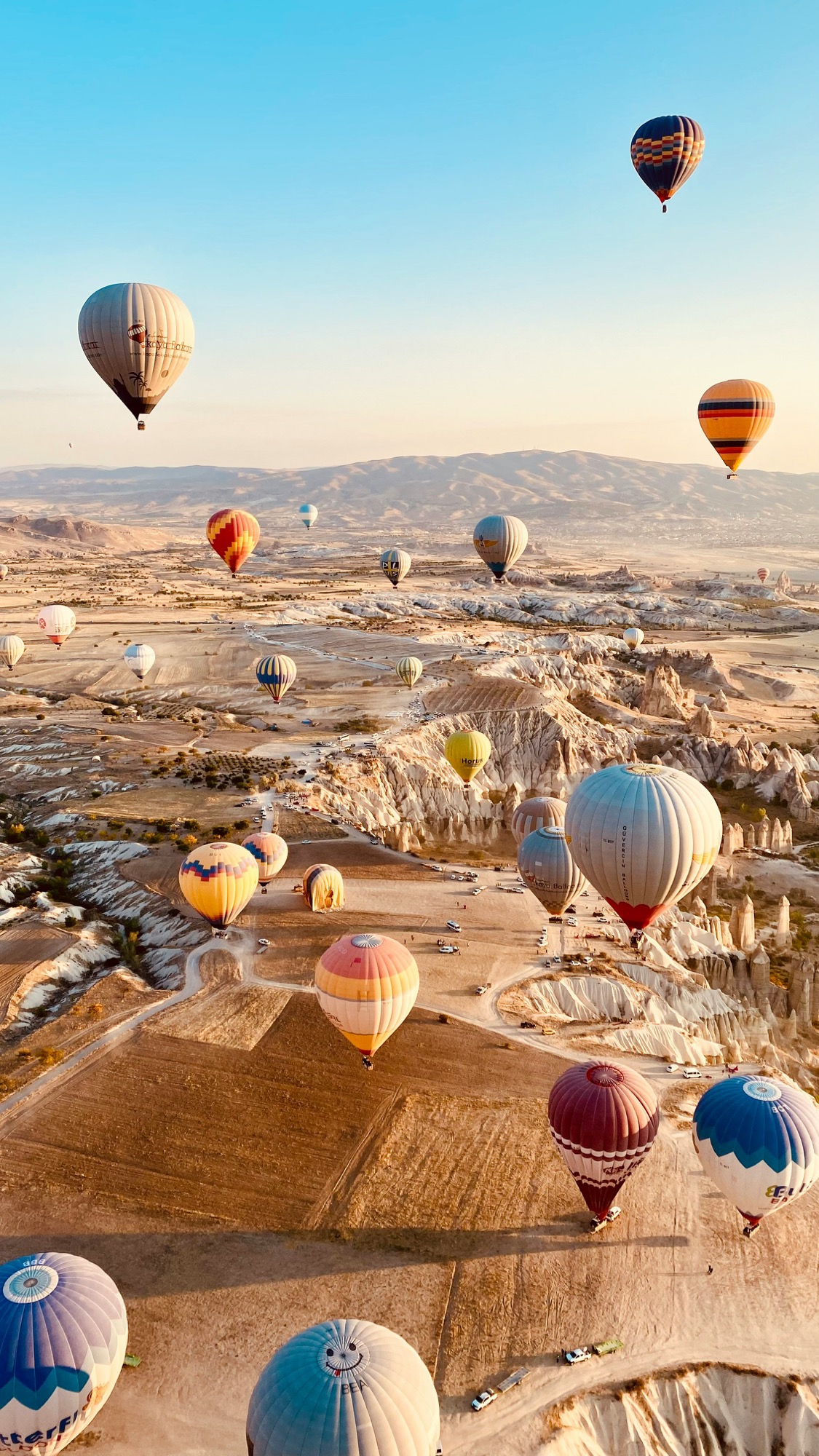 Hot-air balloons over the Cappadocian valleys at sunrise